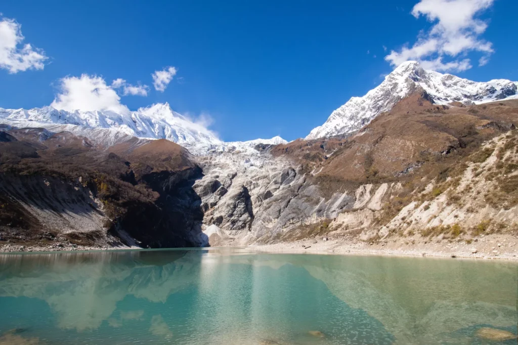 Birendra lake with mt. manaslu in background, gorkha, manaslu circuit trek nepal