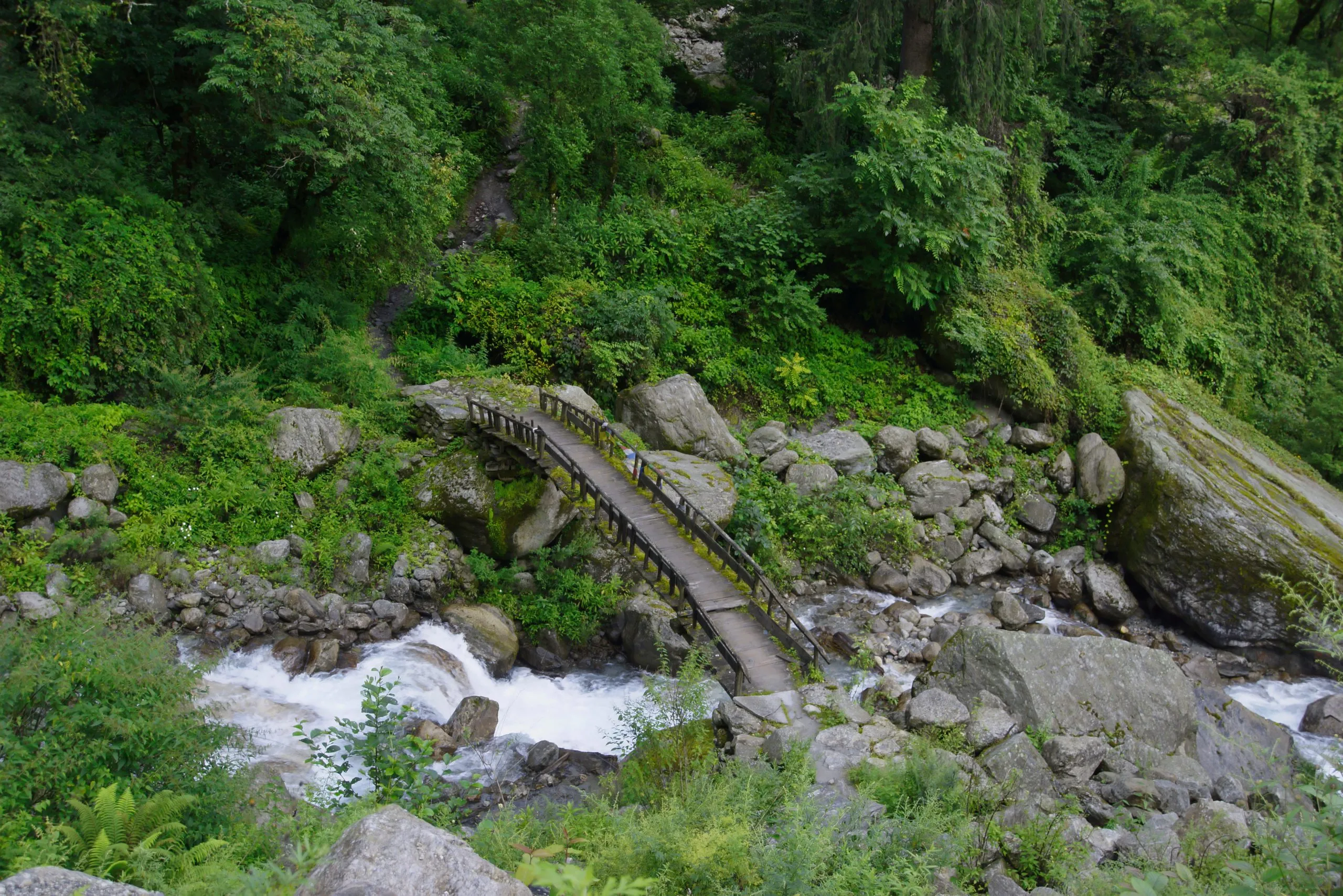 Small wooden bridge to cross a stream on the eastern side of the Annapurna circuit.