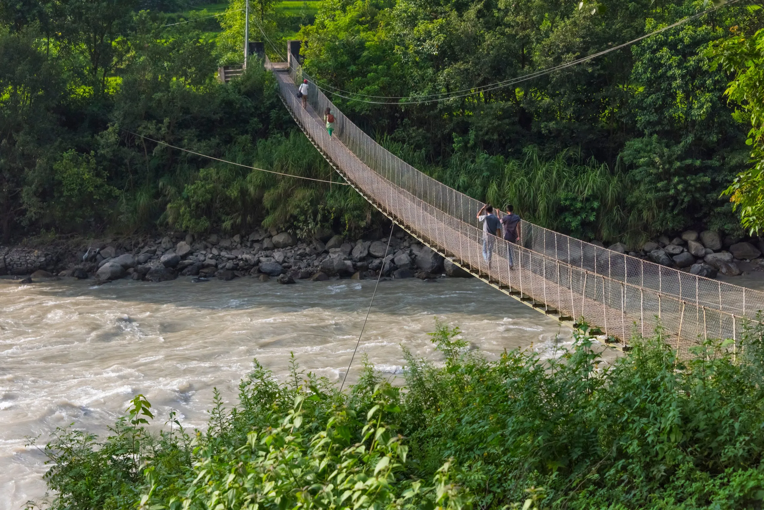 People crossing suspension bridge over Trishuli River, Tupche, Nuwakot District, Province 3, Nepal