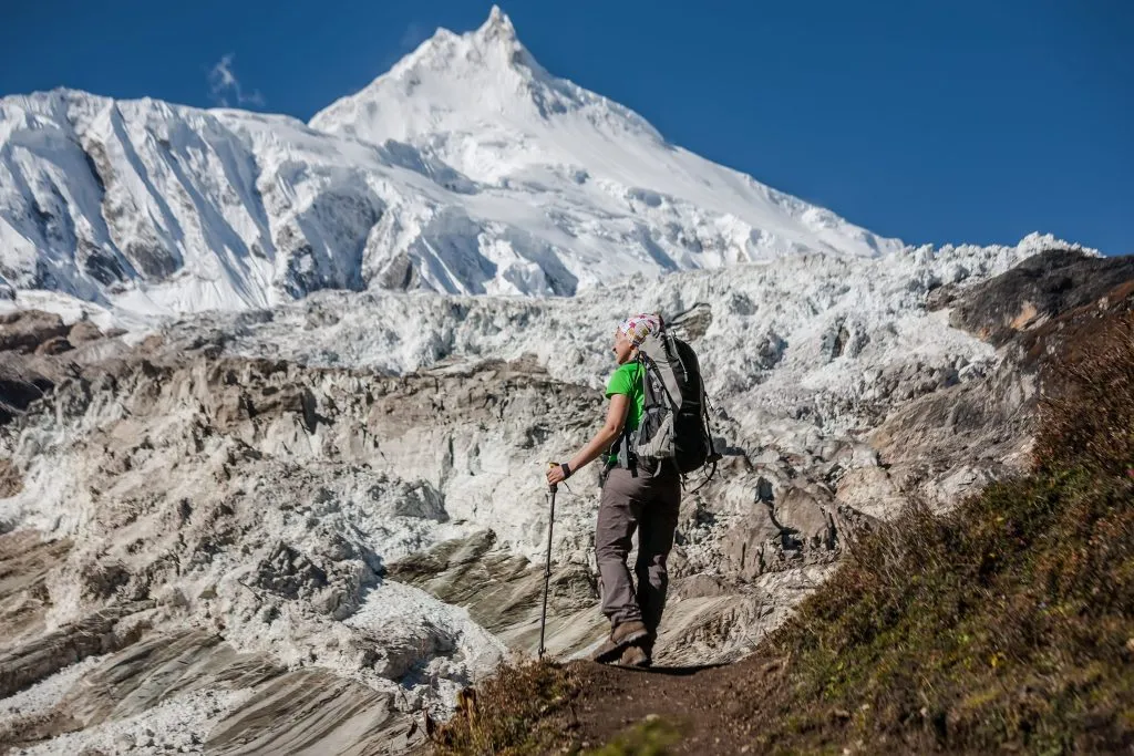 Trekker in front of Manaslu glacier on Manaslu circuit trek in Nepal