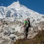 Trekker in front of Manaslu glacier on Manaslu circuit trek in Nepal